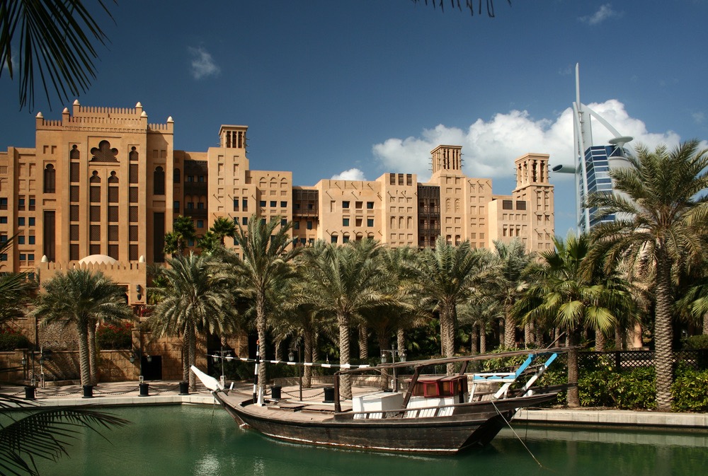 Dubai, Madinat Jumeirah park with the artificial lake and the boat